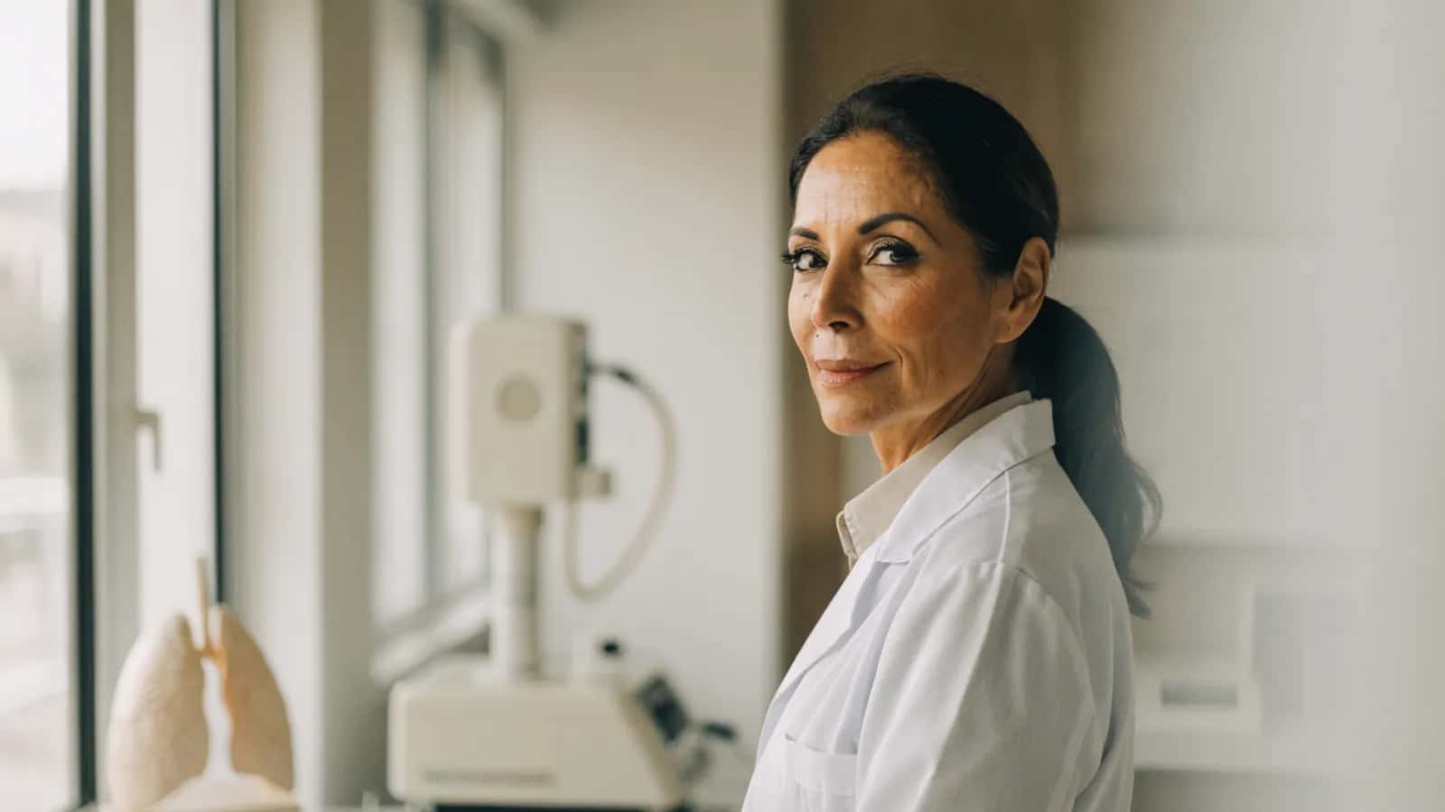 Allergist in a bright clinic with respiratory assessment equipment
