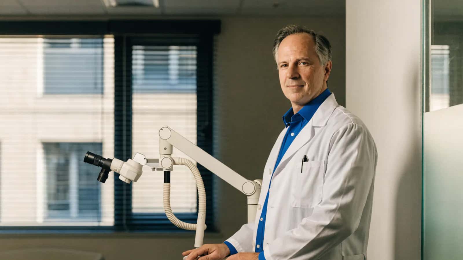 ENT physician beside diagnostic equipment in an otolaryngology clinic